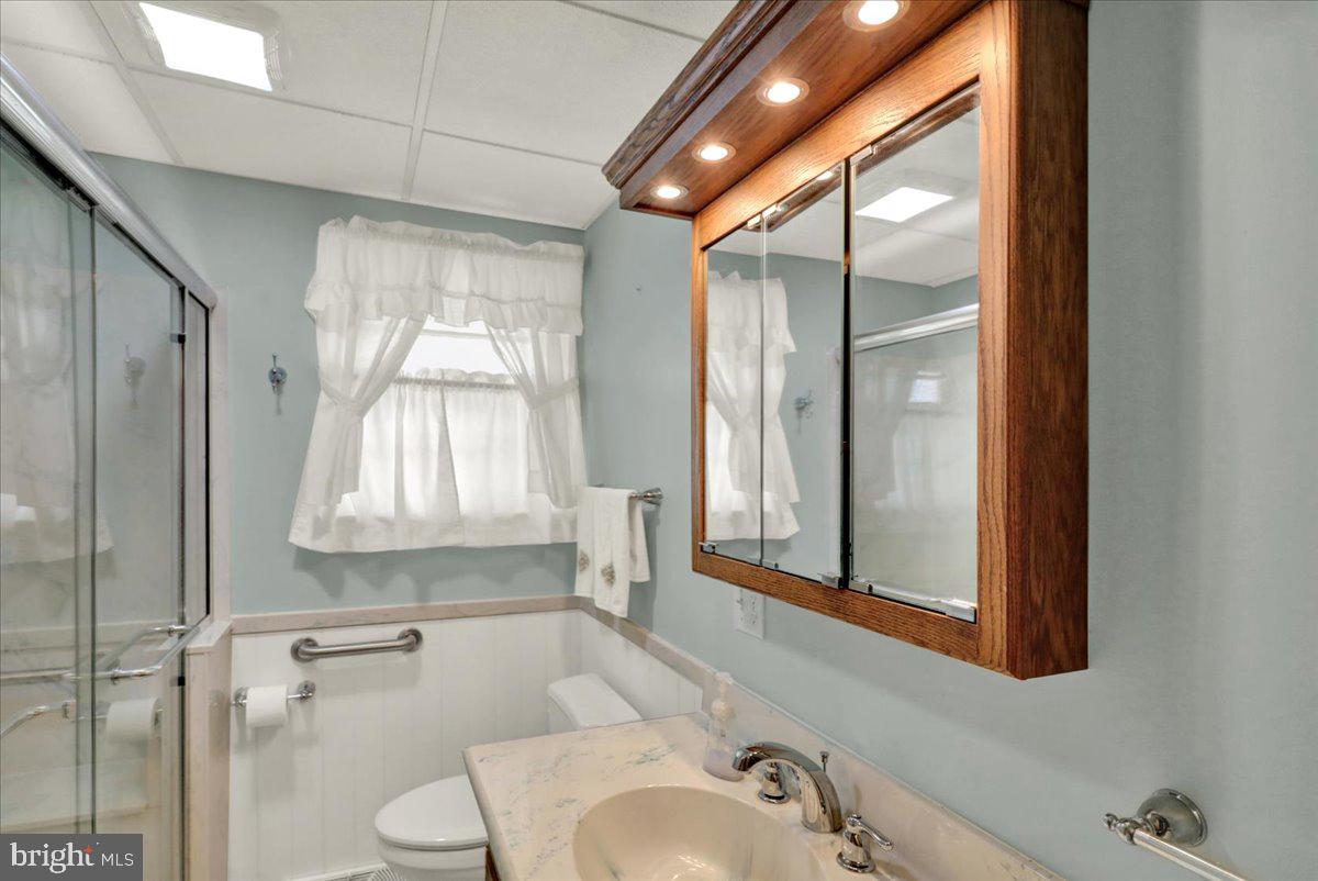 1224 Commonwealth Boulevard Reading, PA 19607 - Photo 12 of 27 a bathroom with a sink a toilet and a mirror