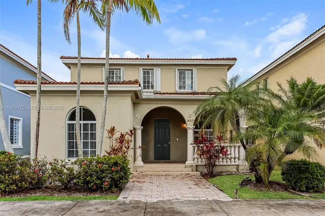 a front view of a house with a garden