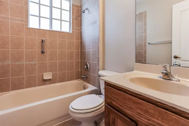 a bathroom with a sink a toilet and bathtub