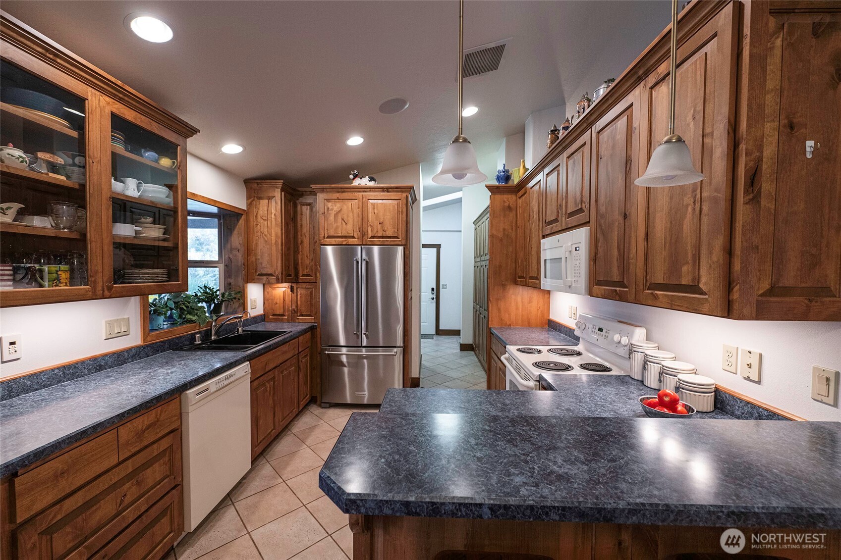 211 Last Chance Road Walla Walla, WA 99362 - Photo 13 of 40 a kitchen with stainless steel appliances granite countertop a sink refrigerator and cabinets