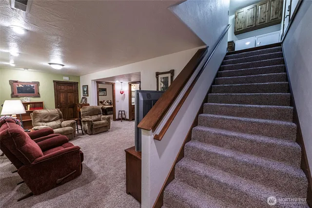 a living room with furniture and stairs