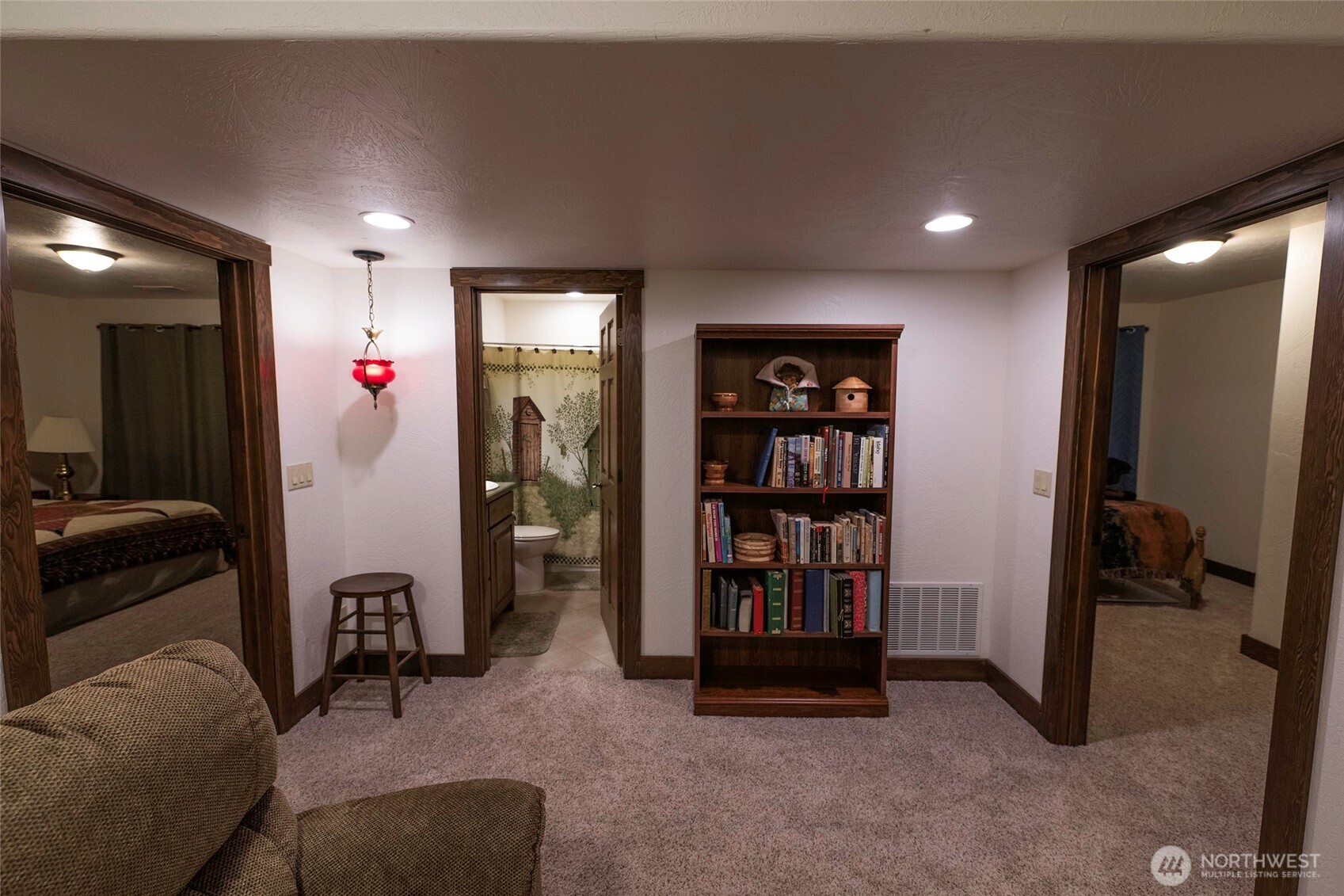 211 Last Chance Road Walla Walla, WA 99362 - Photo 22 of 40 a living room with furniture and a book shelf