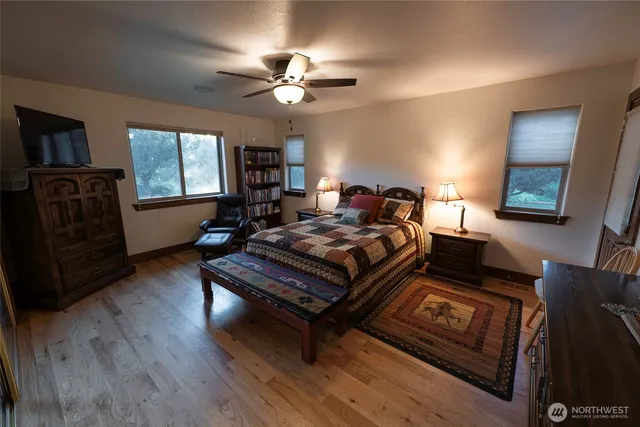 a bedroom with furniture and wooden floor