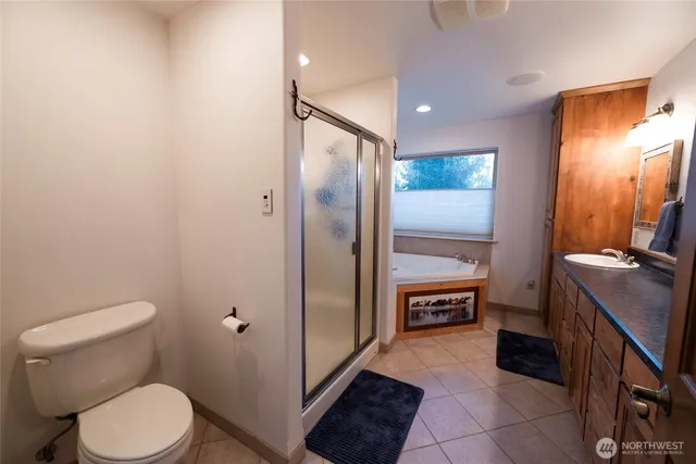 a bathroom with a toilet a sink and mirror