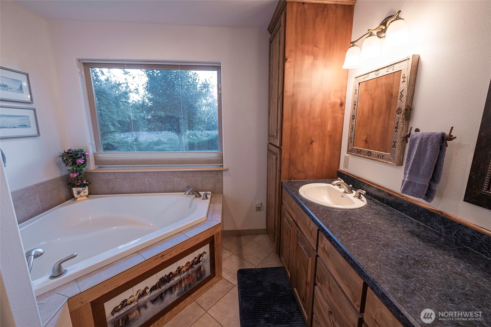 211 Last Chance Road Walla Walla, WA 99362 - Photo 31 of 40 a en suite bathroom with a granite countertop sink a mirror and a bathtub