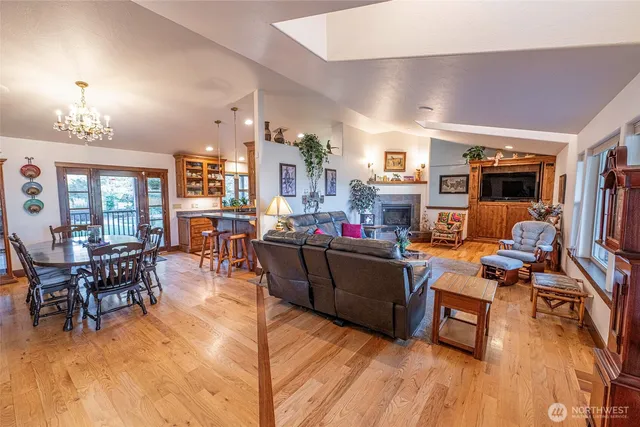a living room with furniture and a dining table with kitchen appliances