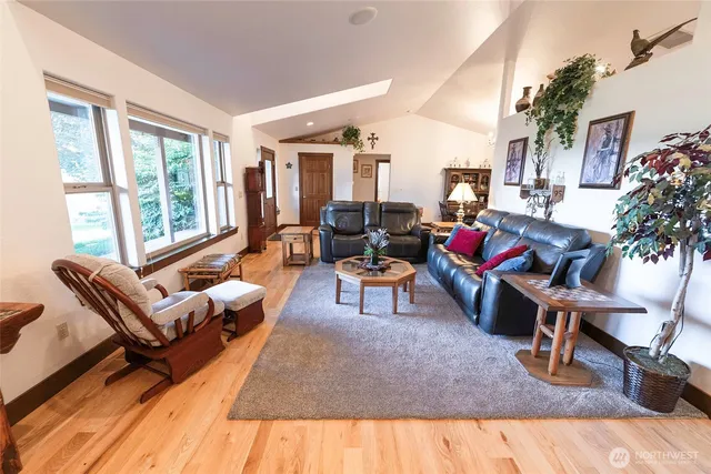 a living room with furniture rug and a large window