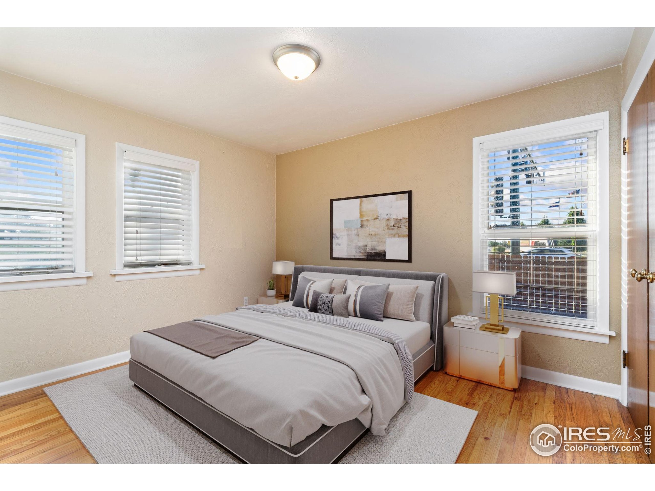 2000 50th Avenue Greeley, CO 80634 - Photo 13 of 34 a bedroom with a bed and a window