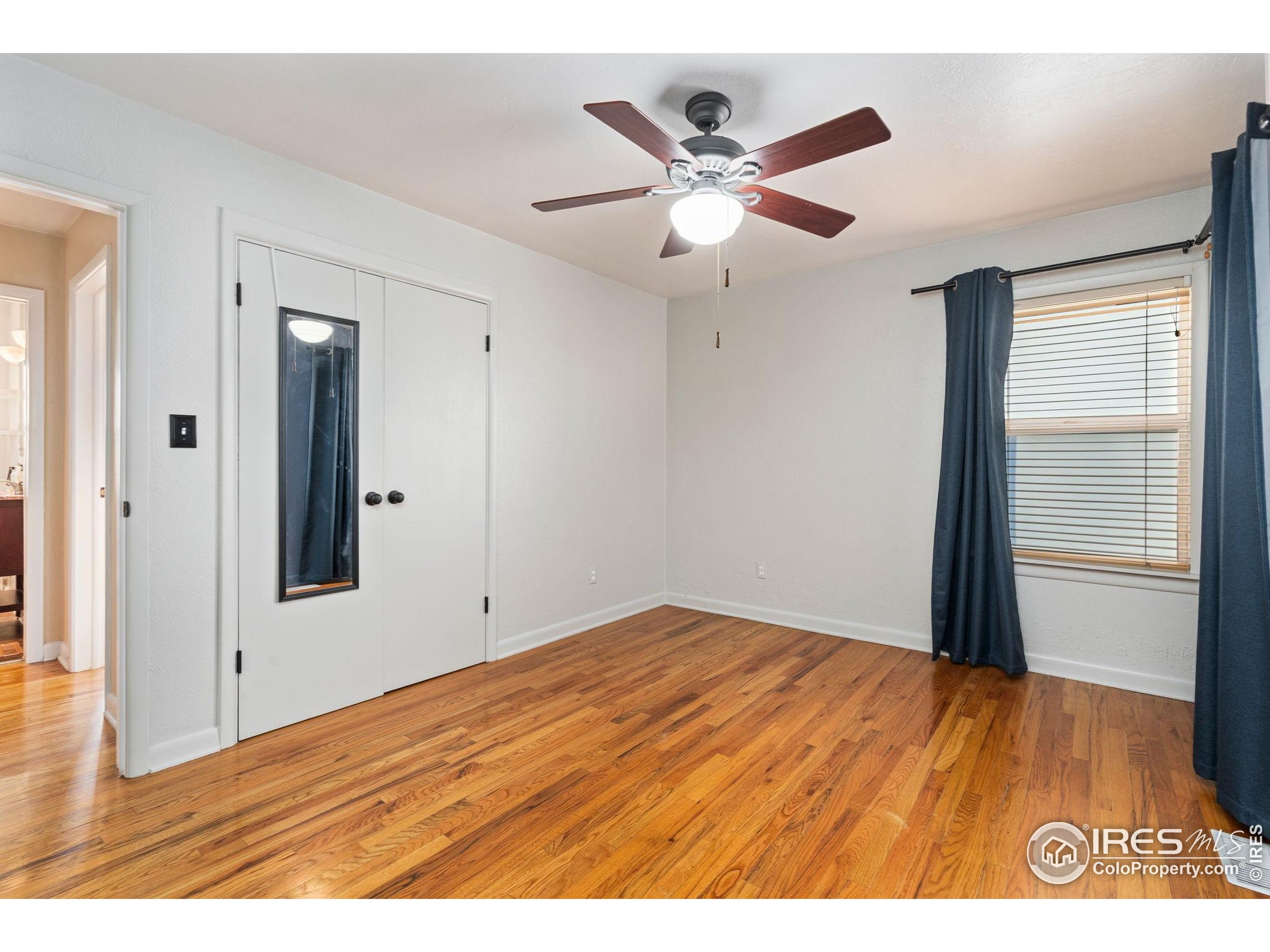 2000 50th Avenue Greeley, CO 80634 - Photo 19 of 34 a view of an empty room and wooden floor