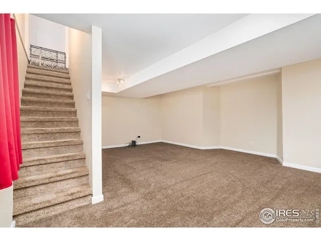 a view of an empty room and stairs
