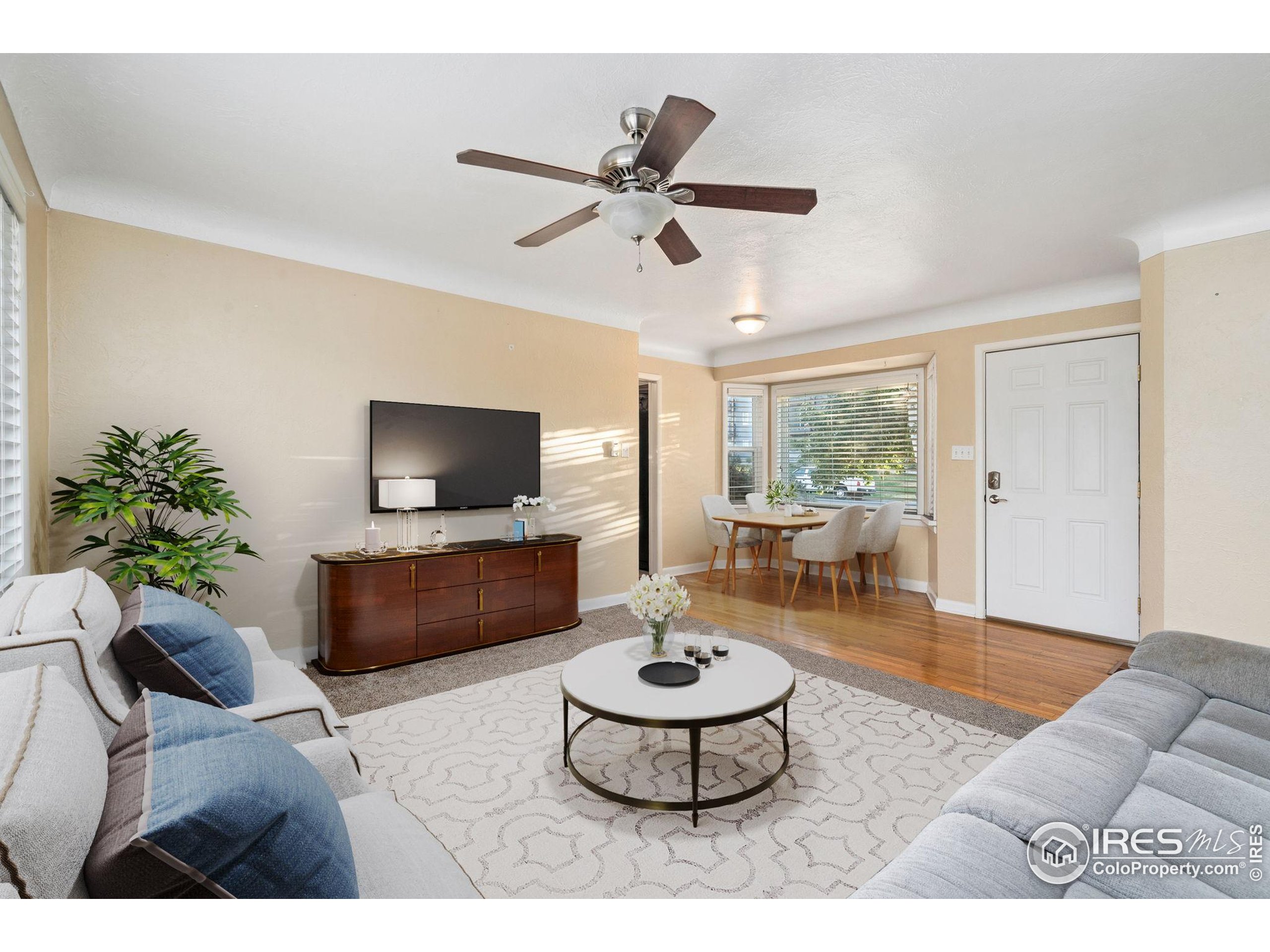 2000 50th Avenue Greeley, CO 80634 - Photo 5 of 34 a living room with furniture and a flat screen tv