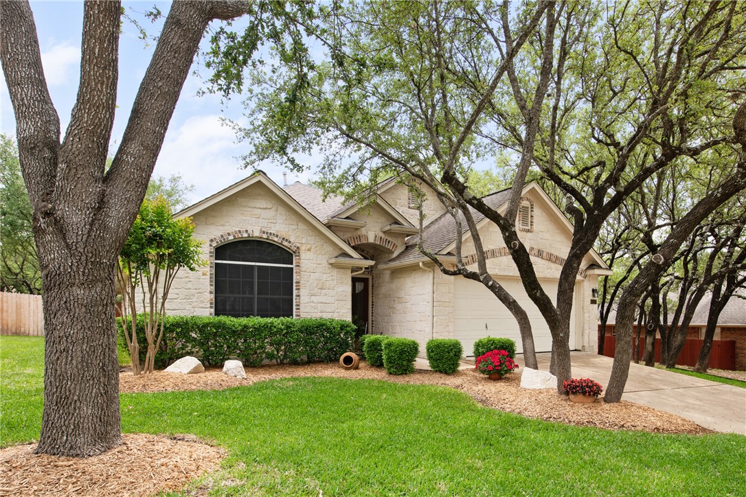 4117 Gazley Lane Austin, TX 78732 - Photo 1 of 1 a front view of a house with a yard and trees
