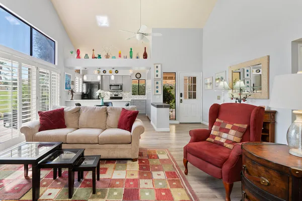 a living room with furniture and a floor to ceiling window