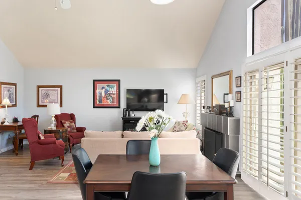 a living room with furniture a flat screen tv and a large window