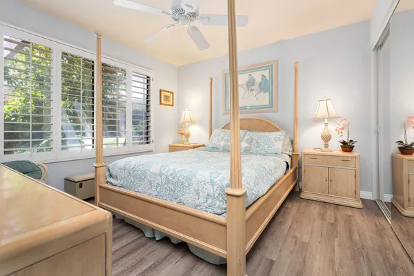 a bedroom with a large bed and a chandelier