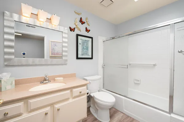 a bathroom with a sink toilet and shower