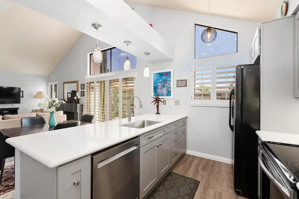 a kitchen with a sink refrigerator and cabinets