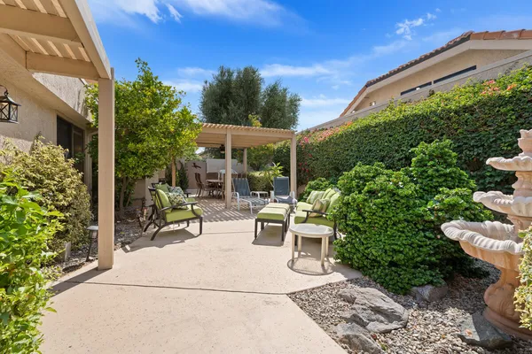 a view of a chairs and table in backyard
