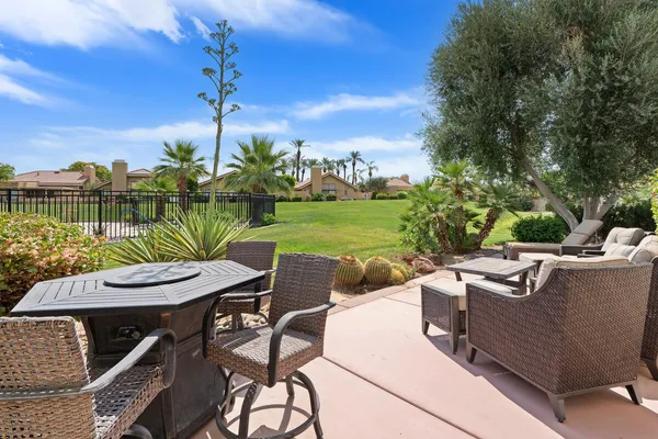 a view of a chairs and table in patio with a lake view