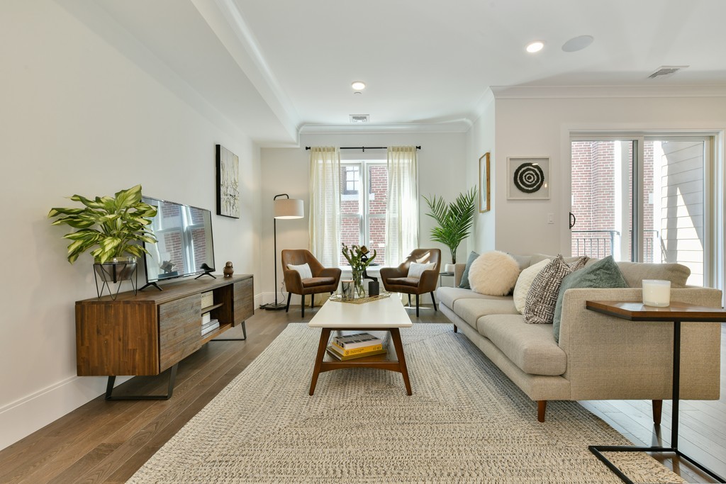 10 Sydney Street, Unit 7 Boston, MA 02125 - Photo 12 of 26 a living room with furniture a flat screen tv and a large window