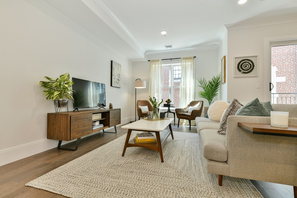 10 Sydney Street, Unit 7 Boston, MA 02125 - Photo 16 of 26 a living room with furniture and a flat screen tv
