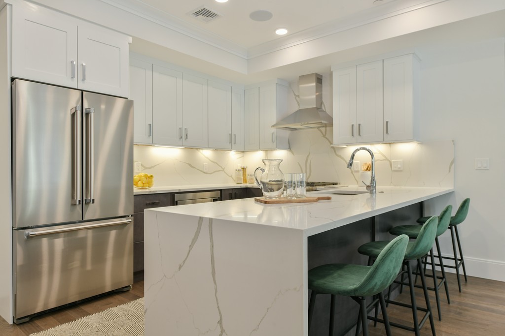 10 Sydney Street, Unit 7 Boston, MA 02125 - Photo 22 of 26 a kitchen with appliances cabinets and wooden floor