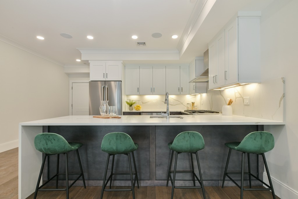10 Sydney Street, Unit 7 Boston, MA 02125 - Photo 23 of 26 a kitchen with cabinets and chairs in it