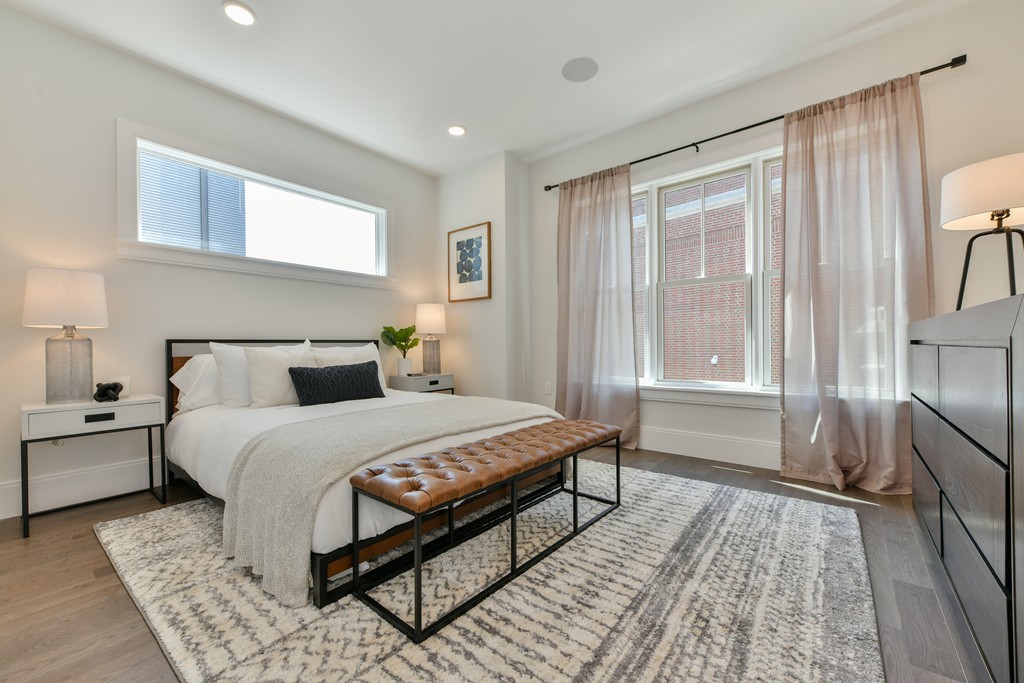 10 Sydney Street, Unit 7 Boston, MA 02125 - Photo 3 of 26 a bedroom with a bed and wooden floor