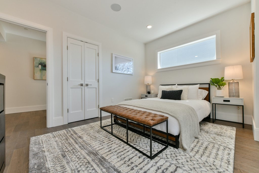 10 Sydney Street, Unit 7 Boston, MA 02125 - Photo 4 of 26 a bedroom with a bed and wooden floor