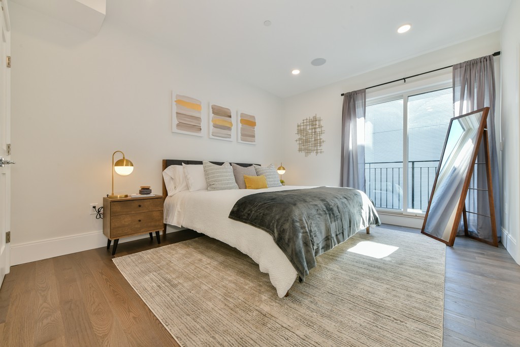 10 Sydney Street, Unit 7 Boston, MA 02125 - Photo 6 of 26 a bedroom with a bed and wooden floor