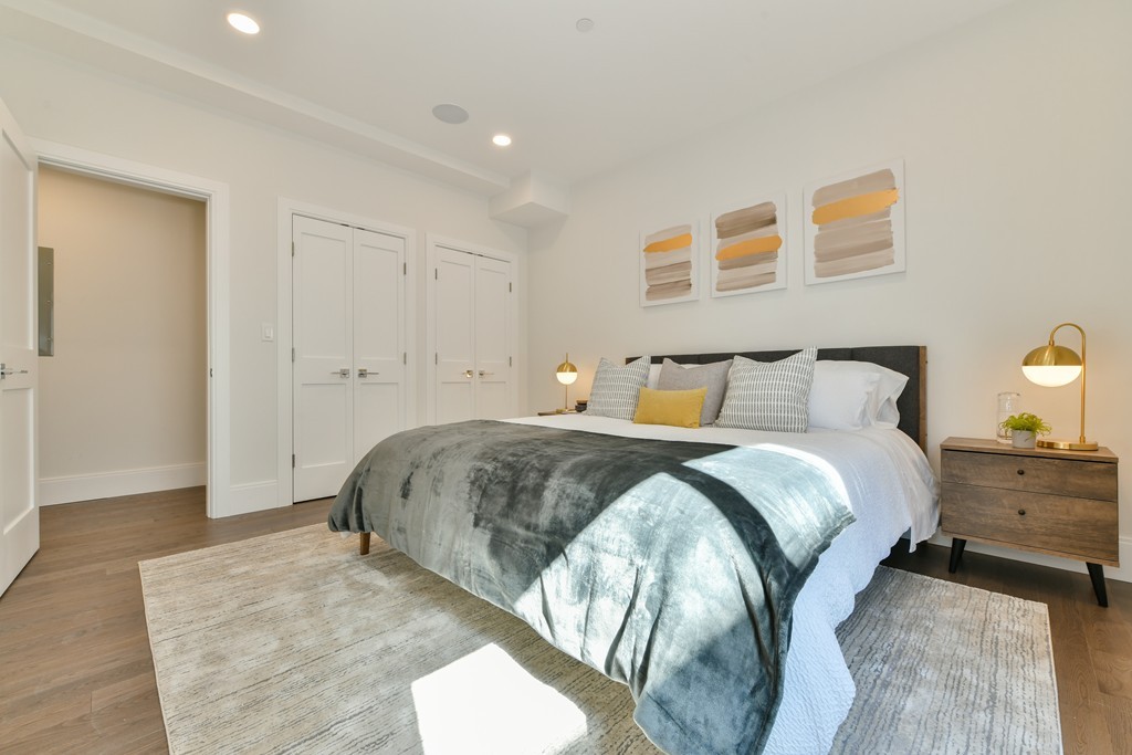 10 Sydney Street, Unit 7 Boston, MA 02125 - Photo 7 of 26 a bedroom with a bed and a lamp
