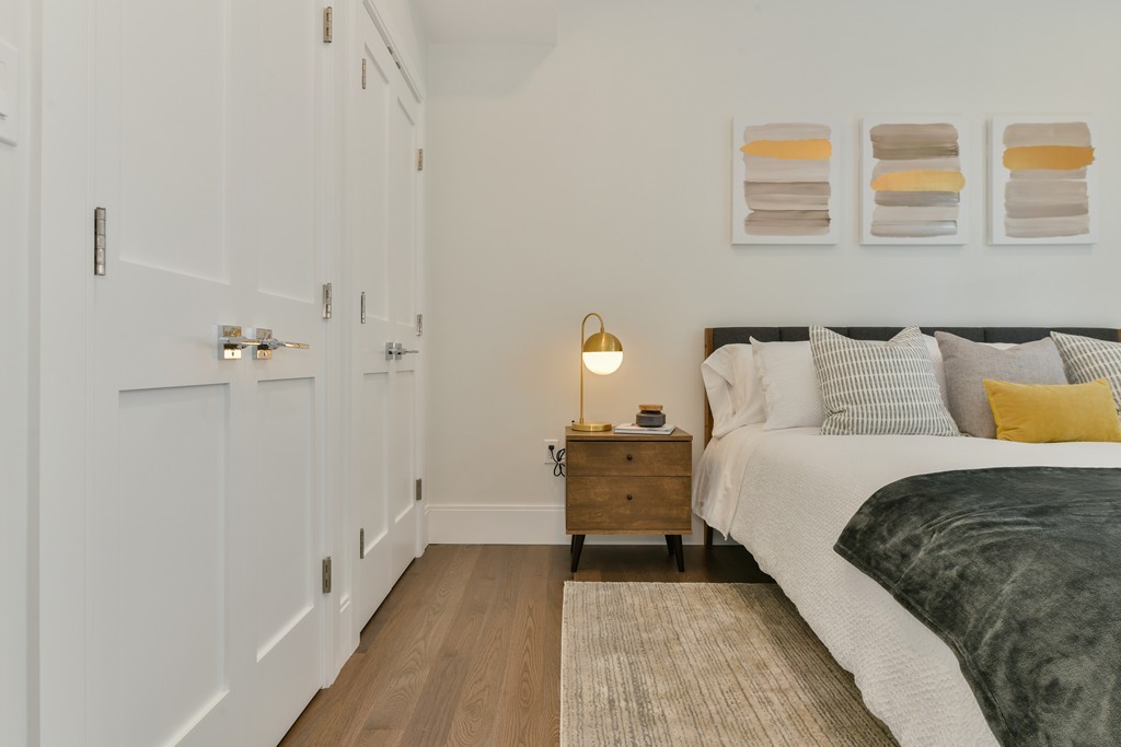 10 Sydney Street, Unit 7 Boston, MA 02125 - Photo 9 of 26 a bedroom with a bed and a table