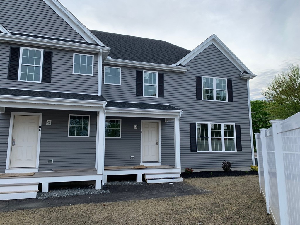 11 Mendon Road, Unit A Attleboro, MA 02703 - Photo 2 of 24 a front view of a house with a yard