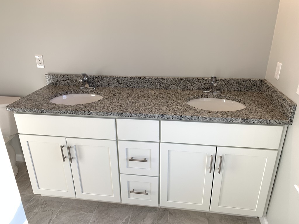 11 Mendon Road, Unit A Attleboro, MA 02703 - Photo 21 of 24 a bathroom with a granite countertop sink and a mirror
