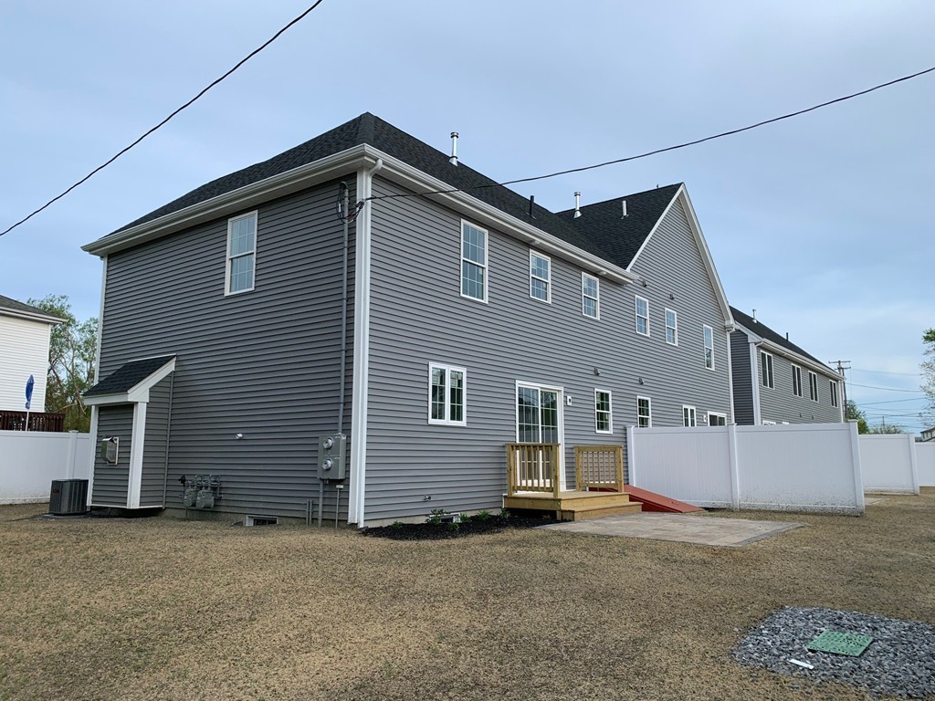 11 Mendon Road, Unit A Attleboro, MA 02703 - Photo 5 of 24 a front view of a house with a garage