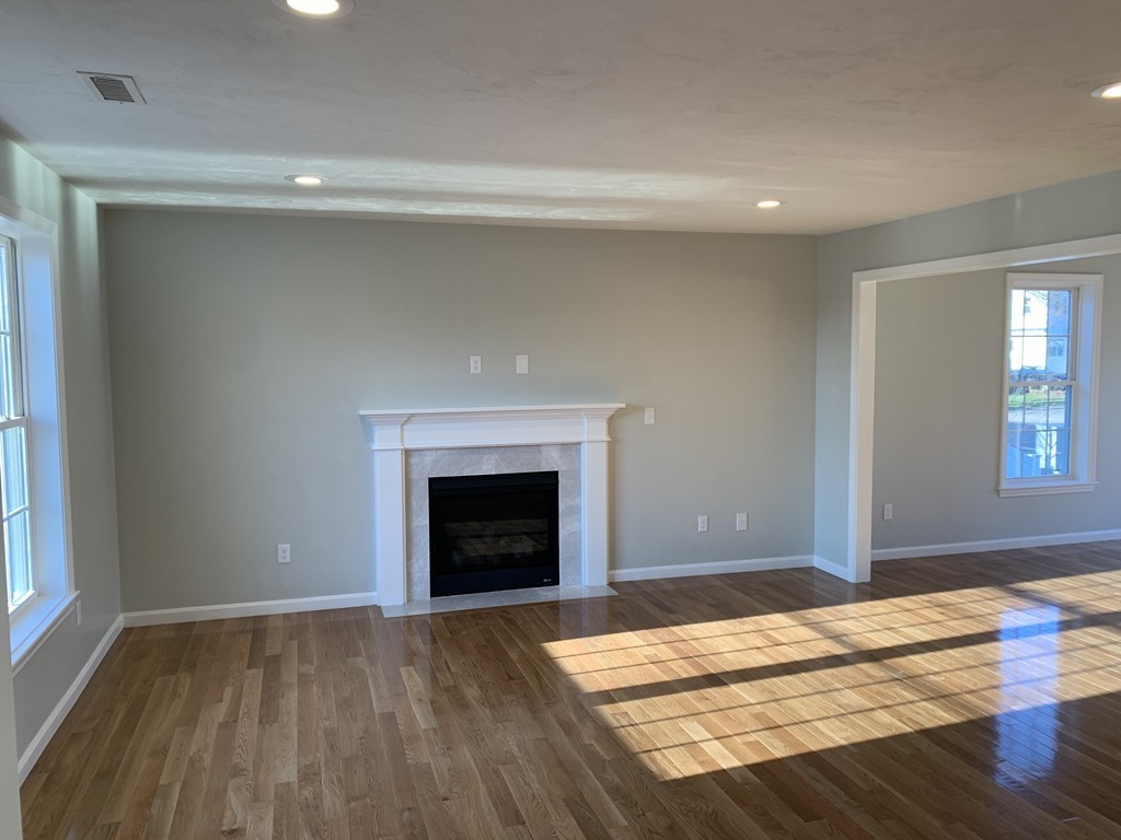 11 Mendon Road, Unit A Attleboro, MA 02703 - Photo 6 of 24 a view of empty room with wooden floor and fireplace