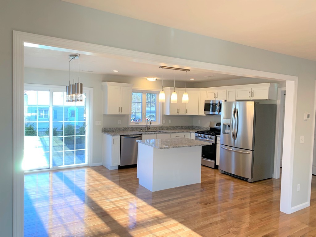 11 Mendon Road, Unit A Attleboro, MA 02703 - Photo 9 of 24 a kitchen with stainless steel appliances granite countertop a refrigerator and a sink