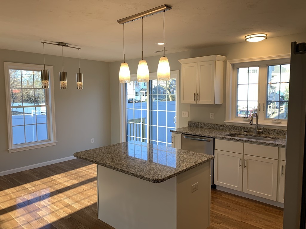 11 Mendon Road, Unit A Attleboro, MA 02703 - Photo 10 of 24 a kitchen with granite countertop white cabinets and window