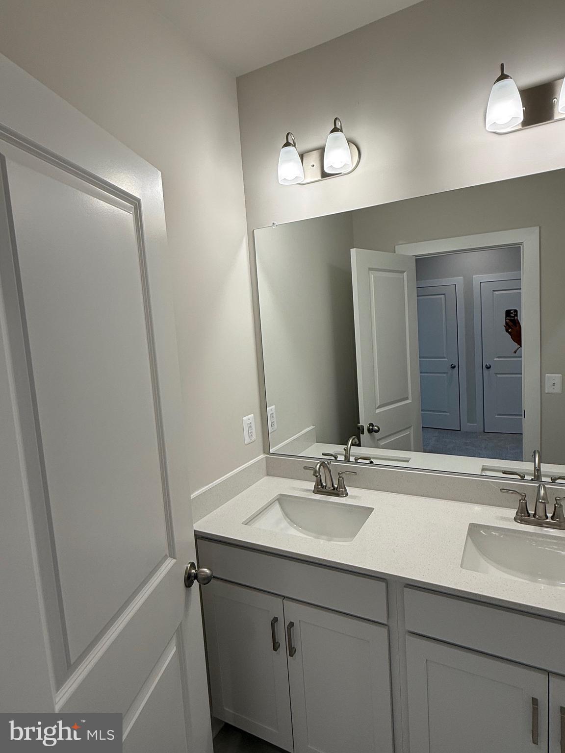 45203 Drowes Terrace Sterling, VA 20166 - Photo 11 of 19 a bathroom with a sink a mirror and a vanity