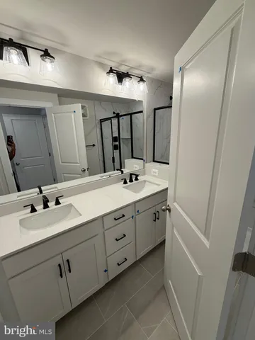 a bathroom with a double vanity sink and mirror