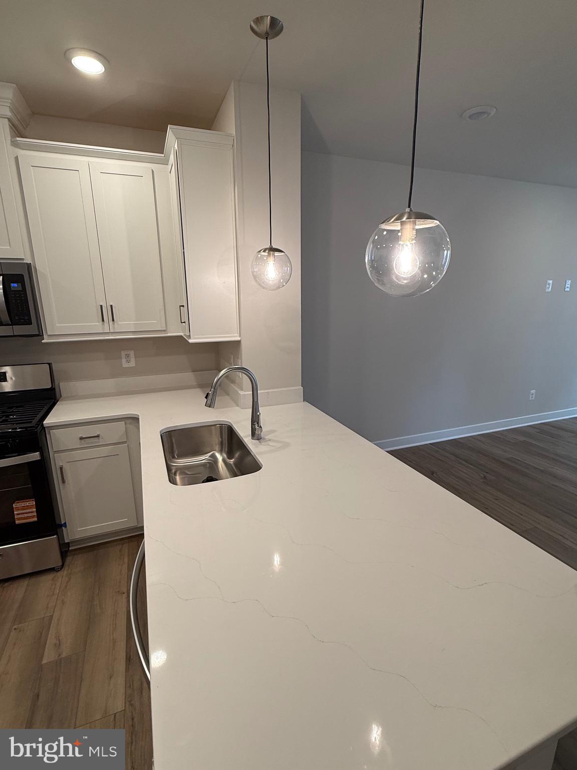 45203 Drowes Terrace Sterling, VA 20166 - Photo 18 of 19 a kitchen with a sink a stove and refrigerator