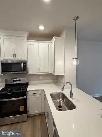 a kitchen that has a sink and a stove top oven