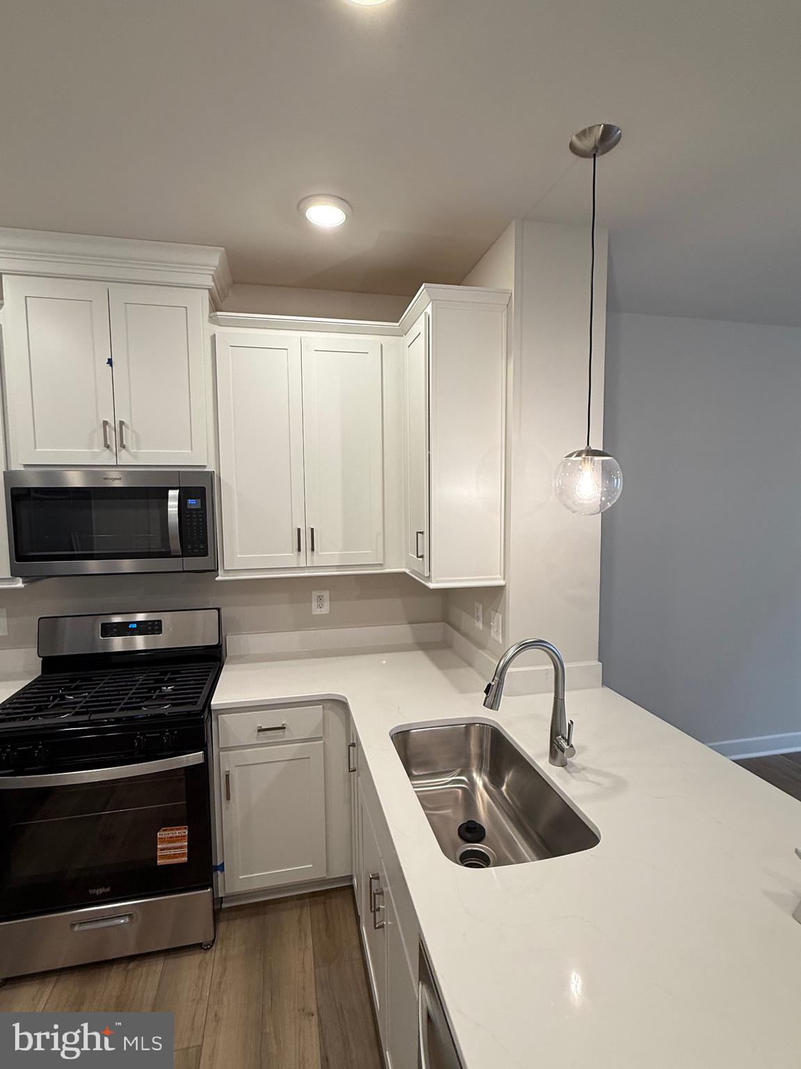 45203 Drowes Terrace Sterling, VA 20166 - Photo 5 of 19 a kitchen that has a sink and a stove top oven
