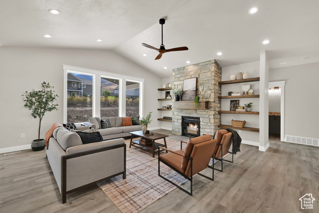 658 West 500 South Logan, UT 84321 - Photo 7 of 25 Living room featuring lofted ceiling, a ceiling fan, light wood finished floors, recessed lighting, and a fireplace