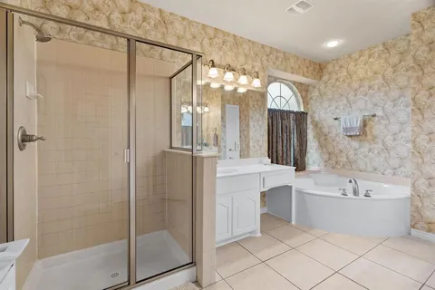a bathroom with a bathtub a shower and a sink