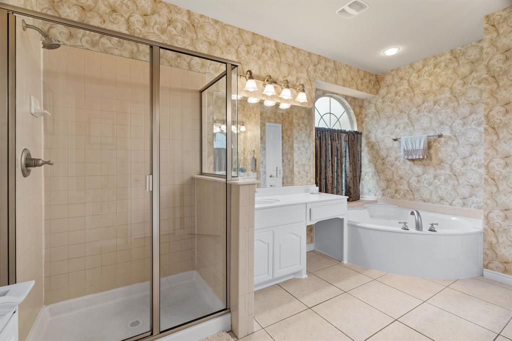 2703 Pottery Trail Corinth, TX 76210 - Photo 17 of 40 a bathroom with a bathtub a shower and a sink
