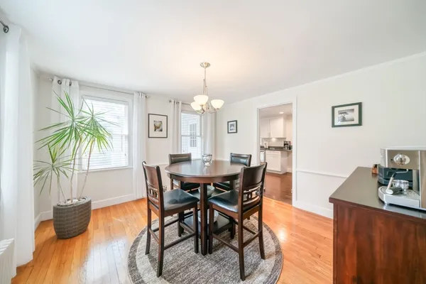 a view of a dining room with furniture and a chandelier