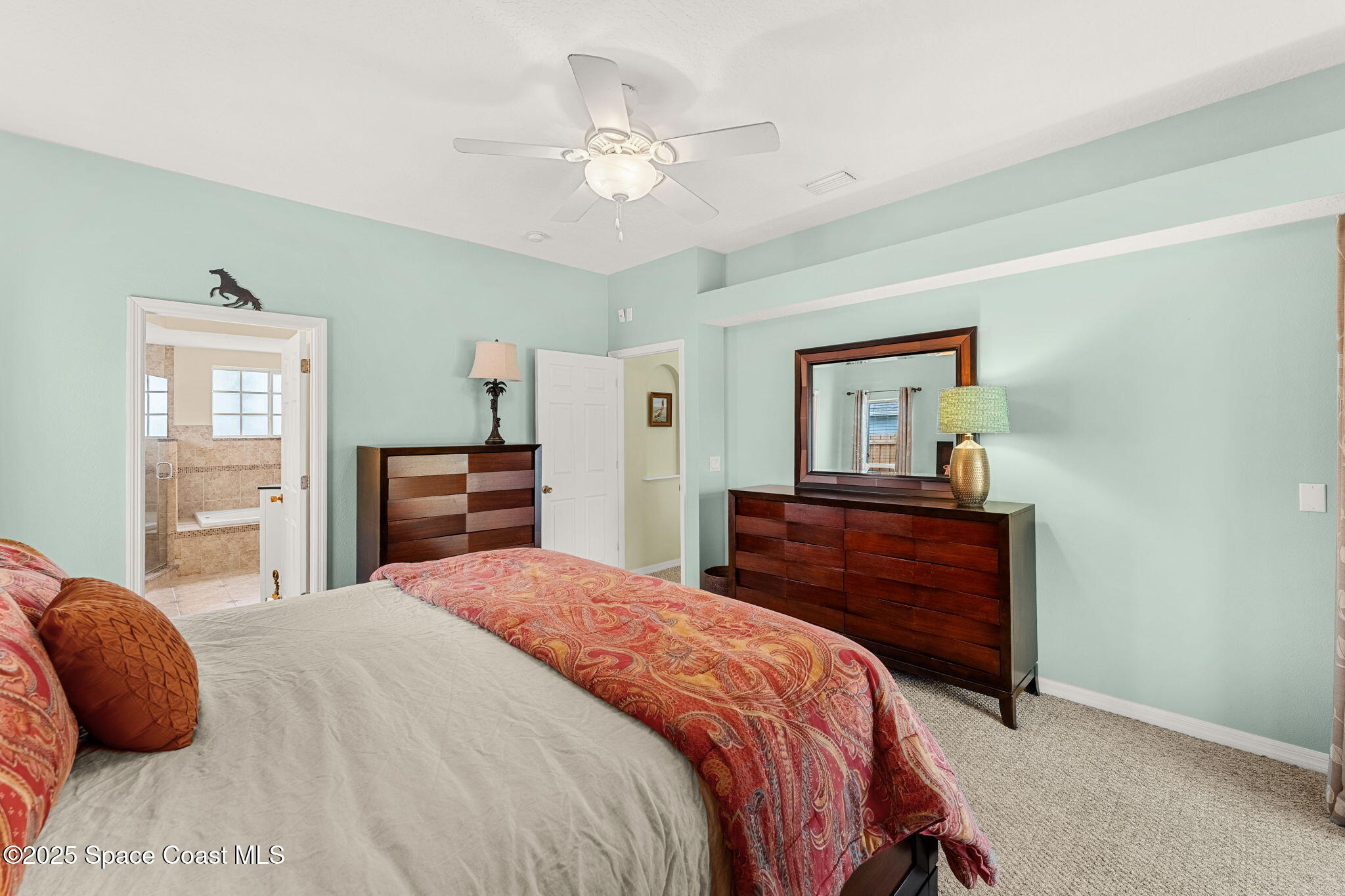 1020 Pelican Lane Rockledge, FL 32955 - Photo 15 of 36 a bedroom with a bed and a chandelier