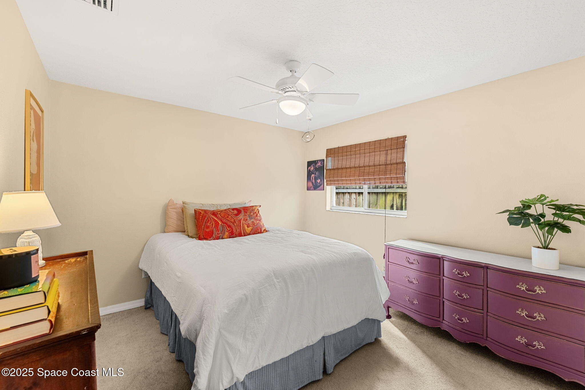1020 Pelican Lane Rockledge, FL 32955 - Photo 21 of 36 a bedroom with a bed and a dresser