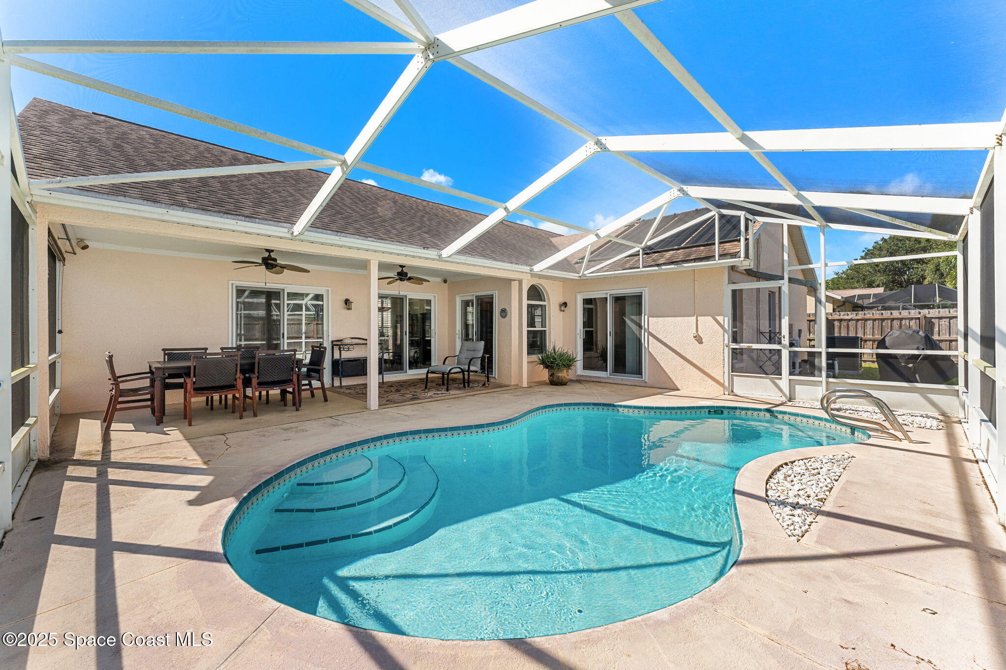 1020 Pelican Lane Rockledge, FL 32955 - Photo 25 of 36 a view of a swimming pool with outdoor seating